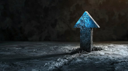 Blue arrow pointing upwards emerges from textured, dark surface, symbolizing growth and progress. contrast between arrow and background creates striking visual impactの素材