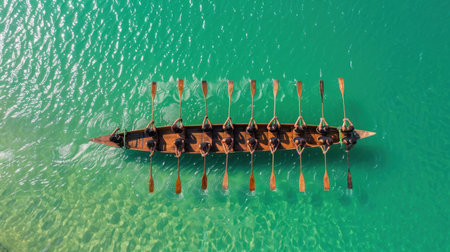 Group of rowers in long boat navigate through clear turquoise waters, showcasing teamwork and coordination. vibrant colors and dynamic movement create inspiring scene of unity and strengthの素材