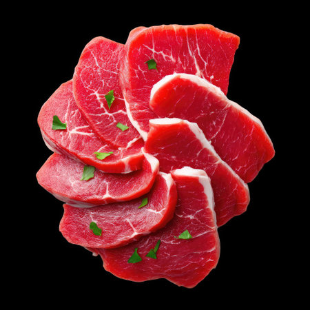A fresh beef slices arranged in fan shape, showcasing vibrant red color and garnished with green herbs, evoke sense of culinary artistry and freshnessの素材