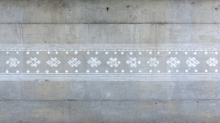 This image showcases a decorative concrete wall featuring intricate geometric patterns and textures. The minimalist design offers a modern aesthetic perfect for various applications.の素材