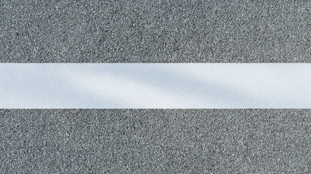 This image features a textured gray surface with a subtle white stripe, ideal for modern minimalist design projects, backgrounds, or artistic compositions.の素材