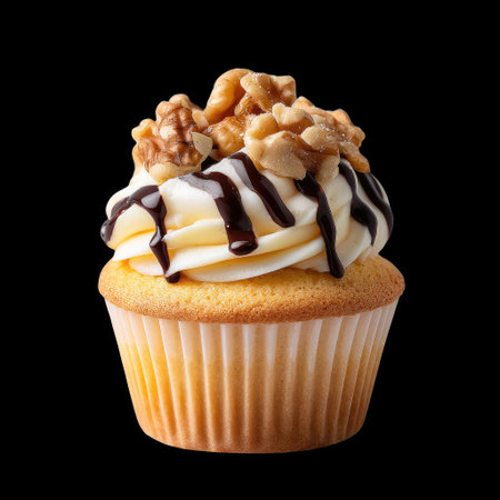 A delectable cupcake featuring silky cream frosting, topped with walnuts and drizzled with chocolate, beautifully presented against a black backdrop.の素材