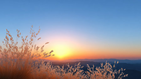Experience the breathtaking beauty of a serene sunrise illuminating the mountains, with golden grass swaying gently in a vibrant atmosphere.の素材