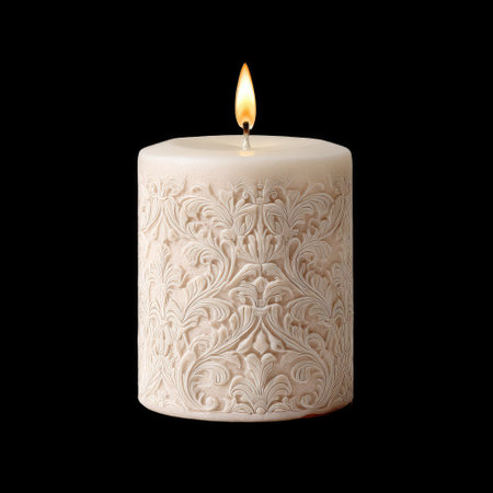 This exquisite white candle features an intricate floral design and a warm flickering flame, perfect for creating a cozy and inviting atmosphere in any space.の素材
