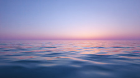 A peaceful and serene view of the ocean waves under a beautiful twilight sky. The water reflects soft pastel colors, creating a calming atmosphere.の素材