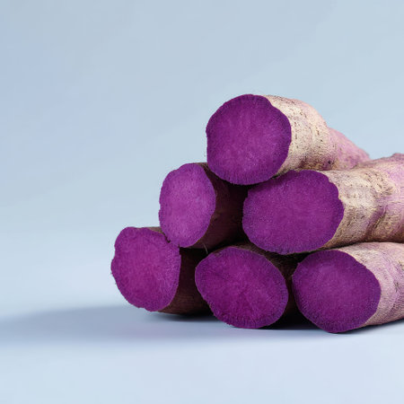 This image features vibrant purple sweet potatoes stacked against a soft background, emphasizing their natural beauty and nutritional benefits. Ideal for health-focused culinary projects.の素材