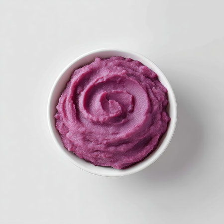 This image features creamy mashed purple sweet potatoes elegantly presented in a white bowl. The vibrant color and smooth texture create an inviting dish ideal for various meals.の素材