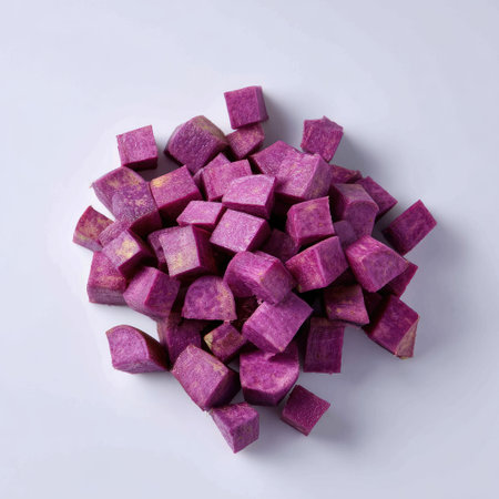 Vibrant purple sweet potato chunks arranged artistically on a clean background, ideal for healthy recipes and creative culinary presentations.の素材