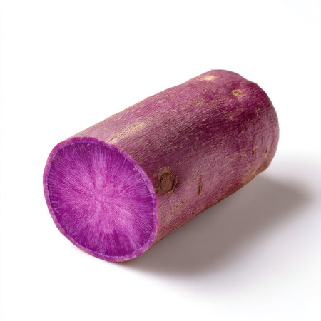 This image features a freshly cut purple yam root against a clean white background, highlighting its vibrant color and unique texture, ideal for culinary purposes.の素材