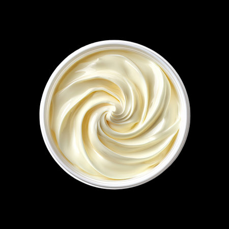 This image showcases a smooth, creamy texture of soft vanilla-flavor cream in a round container. The intricate swirl pattern against a black background highlights the inviting look of this delicious dairy product. Perfect for culinary arts.の素材