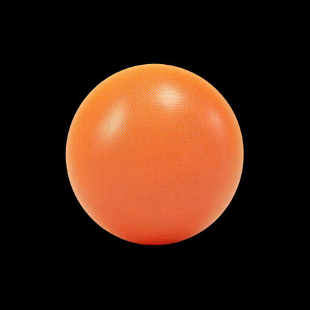 A vibrant orange rubber ball resting on a black background. Ideal for sports, fitness training, and playful activities, this image captures energy and fun.の素材
