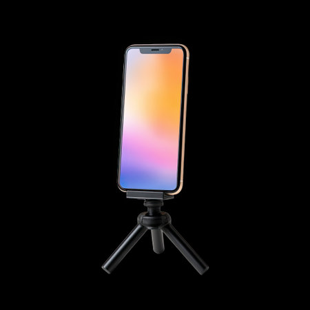 A sleek smartphone rests on a compact tripod, providing a modern solution for capturing photos or videos against a clean black backdrop. Perfect for creative projects.の素材