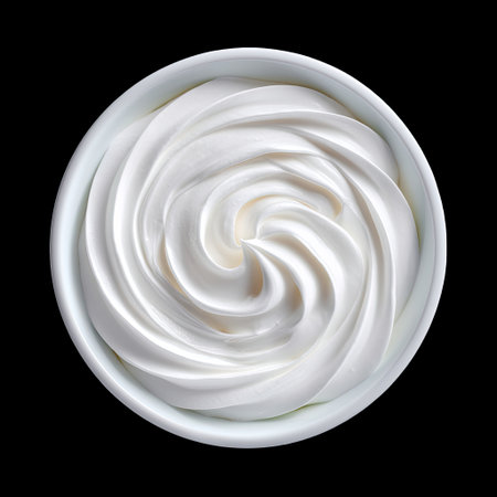 A stunning image showcasing creamy whipped topping in a perfect swirl within a bowl, emphasizing texture and freshness against a dark background.の素材
