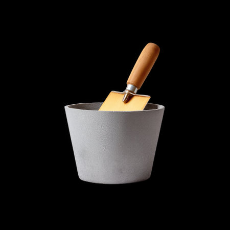 This image showcases a stylish concrete planter featuring a wooden spatula, set against a black background. Ideal for contemporary home decor and gardening.の素材