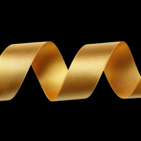 This stunning image features a golden ribbon gracefully flowing against a black background, ideal for design projects, invitations, or festive decorations.の素材