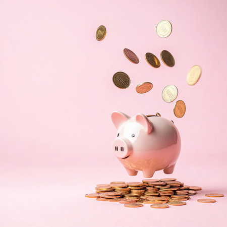 Piggy bank and falling coins on pastel background with copy spaceの素材