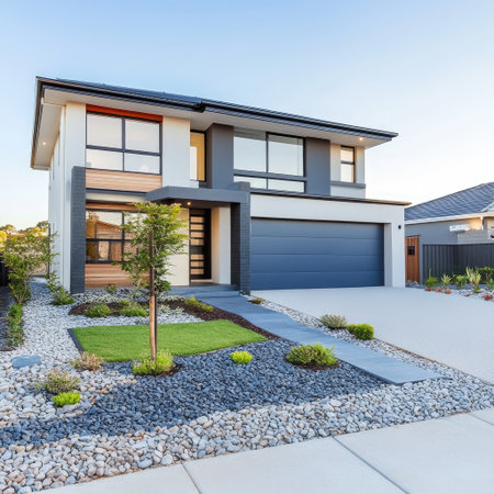 Modern detached house with garage and gravel front yard in a residential suburbの素材