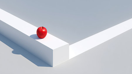 A striking red apple rests delicately on a sleek white geometric block in a minimalist setting, creating an engaging visual contrast.の素材
