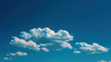A picturesque vision of soft white clouds drifting across a pristine blue sky. This serene landscape offers a tranquil atmosphere perfect for nature lovers and artists.の素材