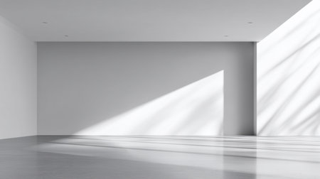 This image showcases a minimalist interior space with white walls and large windows. Sunlight pours in, creating beautifully defined shadows and a serene atmosphere.の素材