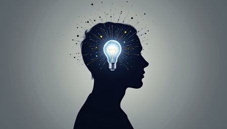This artistic image features a silhouette of a person with a glowing light bulb in the mind, symbolizing creativity and inspiration. The design evokes imagination and innovative thinking.の素材