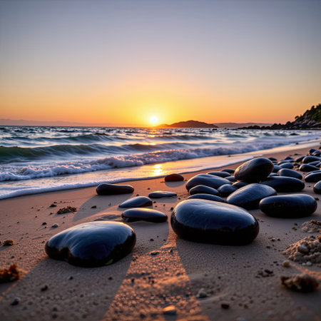 A serene beach scene capturing smooth stones along the shoreline at sunset, with gentle waves creating a relaxing atmosphere and beautiful reflections.の素材