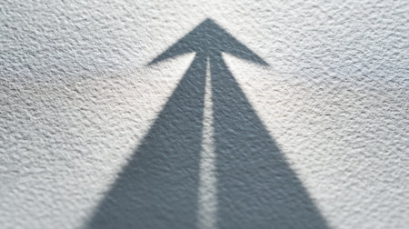 This image features arrow shadows casting an inspiring motif, symbolizing direction and motivation on a textured surface, perfect for themes of guidance and achievement.の素材