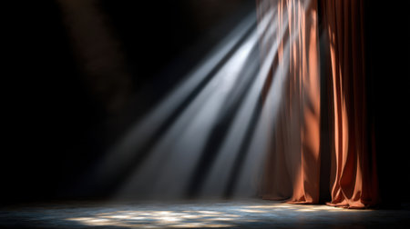 A captivating scene showcasing soft light rays breaking through rich velvet curtains in a dark theater space, perfect for conveying mood and atmosphere.の素材