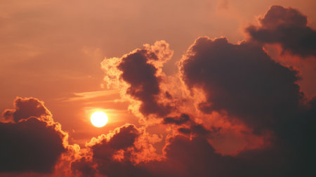 Experience the serene beauty of a sunset with dynamic clouds illuminated in vibrant orange and red hues, creating a captivating evening sky scene perfect for relaxation.の素材