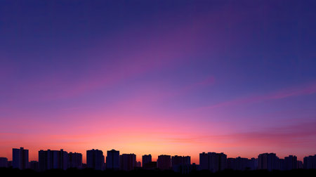 A stunning urban skyline at golden hour, showcasing silhouetted towers against vibrant purple and pink sky, creating serene and captivating atmosphereの素材