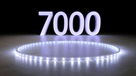 A glowing number 7000 illuminated by led lights stands prominently in dark space, creating striking visual effect. surrounding circular light adds to ambiance, enhancing overall presentationの素材