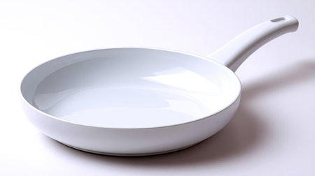 A clean, isolated frying pan with smooth white surface and comfortable handle, perfect for cooking and frying various dishes. its sleek design adds elegance to any kitchenの素材
