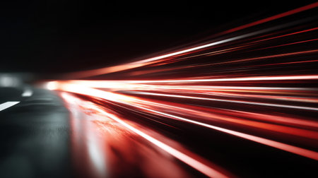 Captivating abstract image showcasing motion blur with red and white lights on a dark road, emphasizing speed and vibrant energy in an urban night setting.の素材