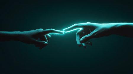 A captivating image of two hands reaching toward each other, illuminated by a glowing light against a dark background, symbolizing connection and unity in a modern world.の素材