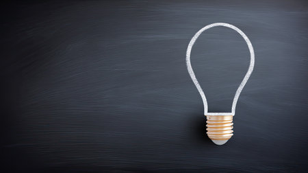 An artistic representation of a light bulb outline against a blackboard background, representing the essence of creativity and innovative thinking for various projects.の素材