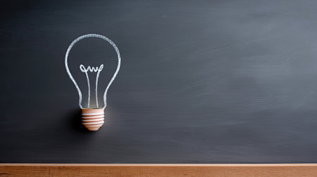 This image showcases a minimalist lightbulb illustration on a chalkboard background, representing innovative ideas and creative inspiration. Perfect for education or design.の素材