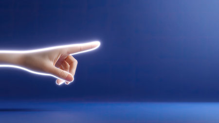 An illuminated hand is pointing towards an empty space on a rich blue background. This image symbolizes direction, creativity, and modern communication.の素材