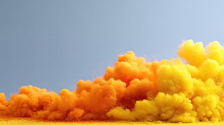 This image captures a vibrant explosion of yellow and orange powder, creating a stunning visual against a clear blue sky. The colorful cloud forms an abstract and playful backdrop, showcasing energy and movement. Ideal for creative projects and artistic themes.の素材