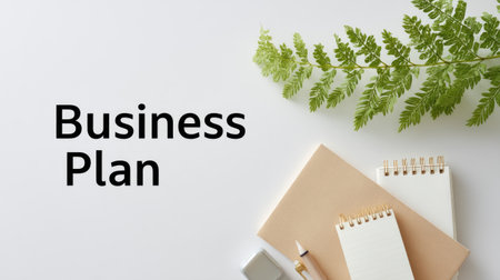 This minimalistic flat lay image features a business plan concept with notebooks and a vibrant green fern on a clean white background, perfect for creative projects.の素材