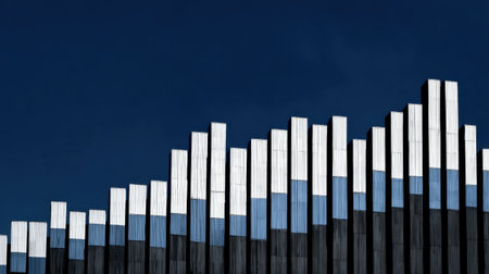 A striking architectural feature showcasing geometric patterns and reflective surfaces against a vivid blue sky, highlighting modern urban design and creativity.の素材