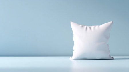 A soft white pillow sits against light blue background, creating serene and minimalistic aesthetic that evokes sense of calm and comfortの素材