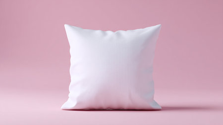 A white square pillow mockup is displayed against soft pastel pink background, creating serene and inviting atmosphere perfect for home decorの素材