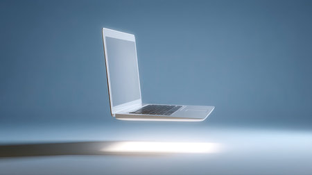 This floating laptop image showcases a modern computer with a clean and minimalist design, evoking innovation and digital technology. The soft blue background enhances the focus on the device, perfect for themes of productivity and creativity.の素材