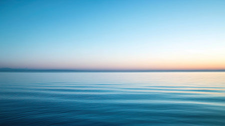 A serene ocean view featuring a smooth surface and a soft evening sky, capturing the tranquility and beauty of nature, perfect for calming visuals.の素材