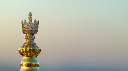 Close-up of a stunning golden crown with intricate details against a soft, blurred background, symbolizing luxury, elegance, and royalty.の素材