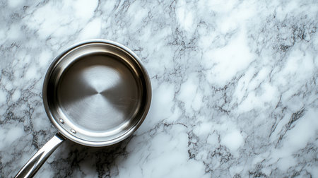 A sleek stainless steel pan rests on a textured marble surface, perfect for showcasing modern kitchen aesthetics. Ideal for cooking and design themes.の素材