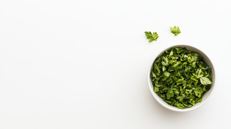 Freshly chopped cilantro in a white bowl on a clean countertop, perfect for enhancing the flavor of various dishes and adding vibrant color.の素材
