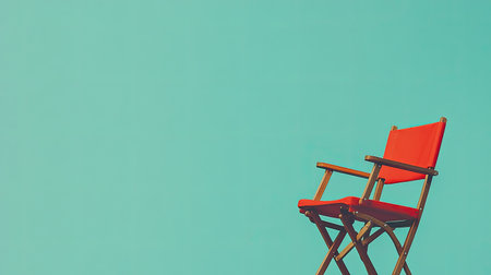 A stylish red chair set against a vibrant turquoise background, perfect for minimalistic decor. This image evokes a sense of calm and creativity.の素材