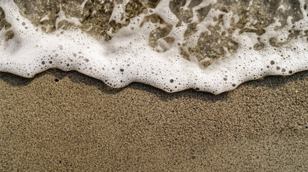 A serene view of gentle waves lapping at a sandy beach, showcasing the beauty of nature and the relaxing atmosphere of coastal environments.の素材