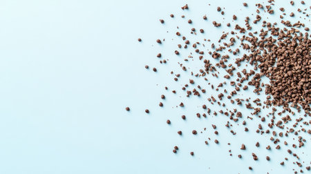 Cocoa powder scattered on a pastel blue backdrop, highlighting its fine texture. Ideal for culinary projects, recipes, and food styling needs.の素材